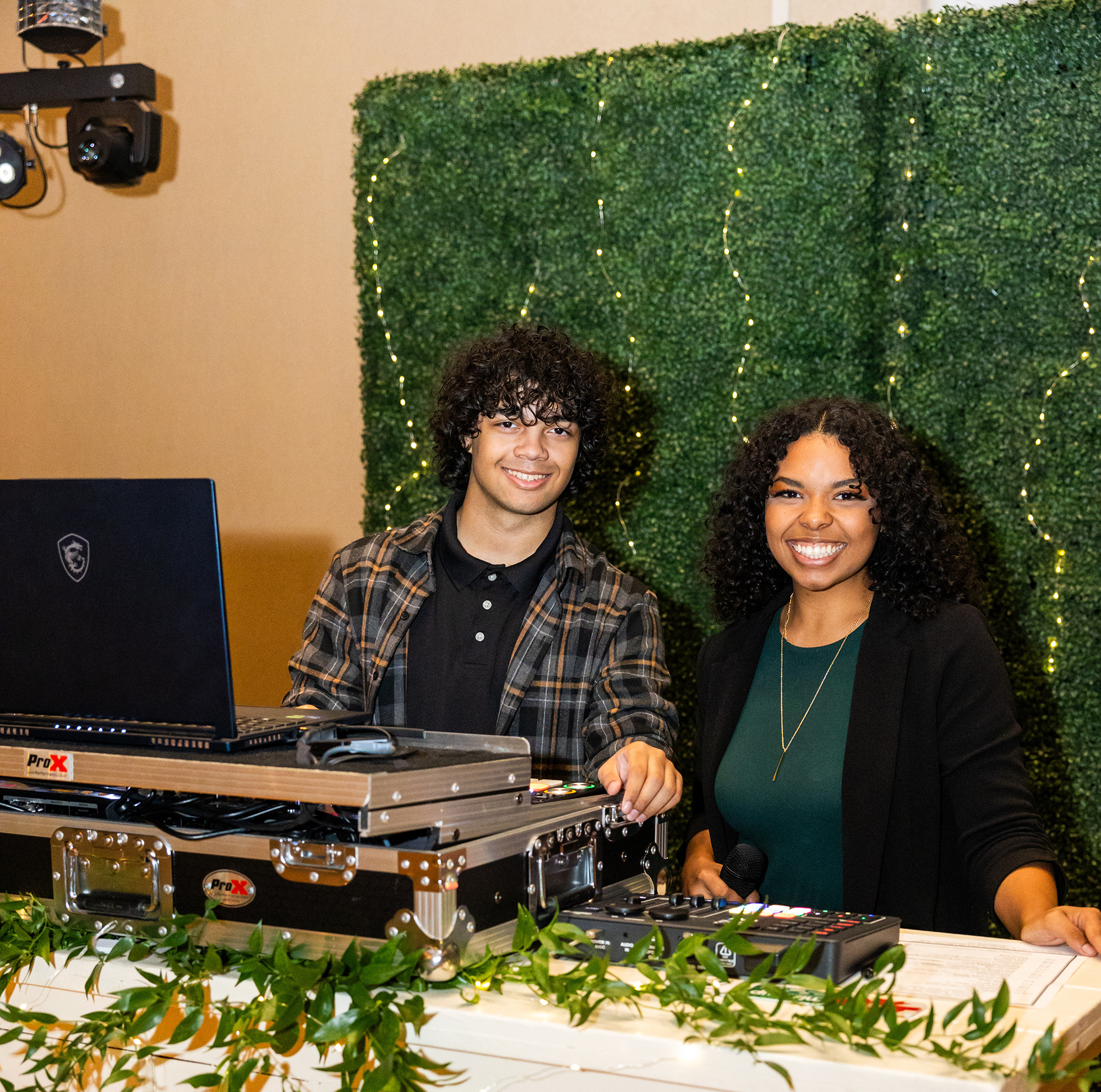 DJ Ace and MC Amara at the booth with a garden feel to the event.